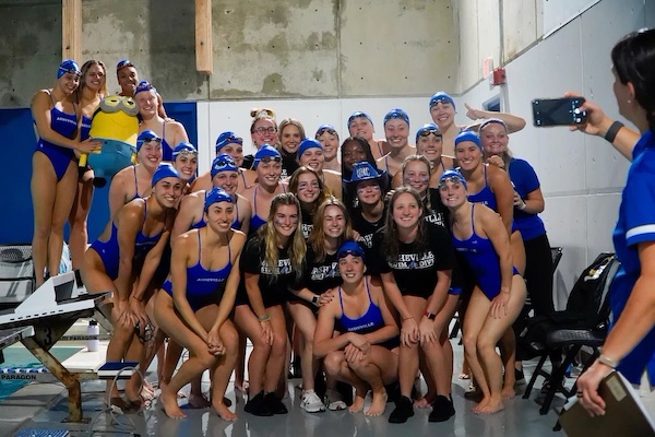 UNCA swim team members gathered together before a meet