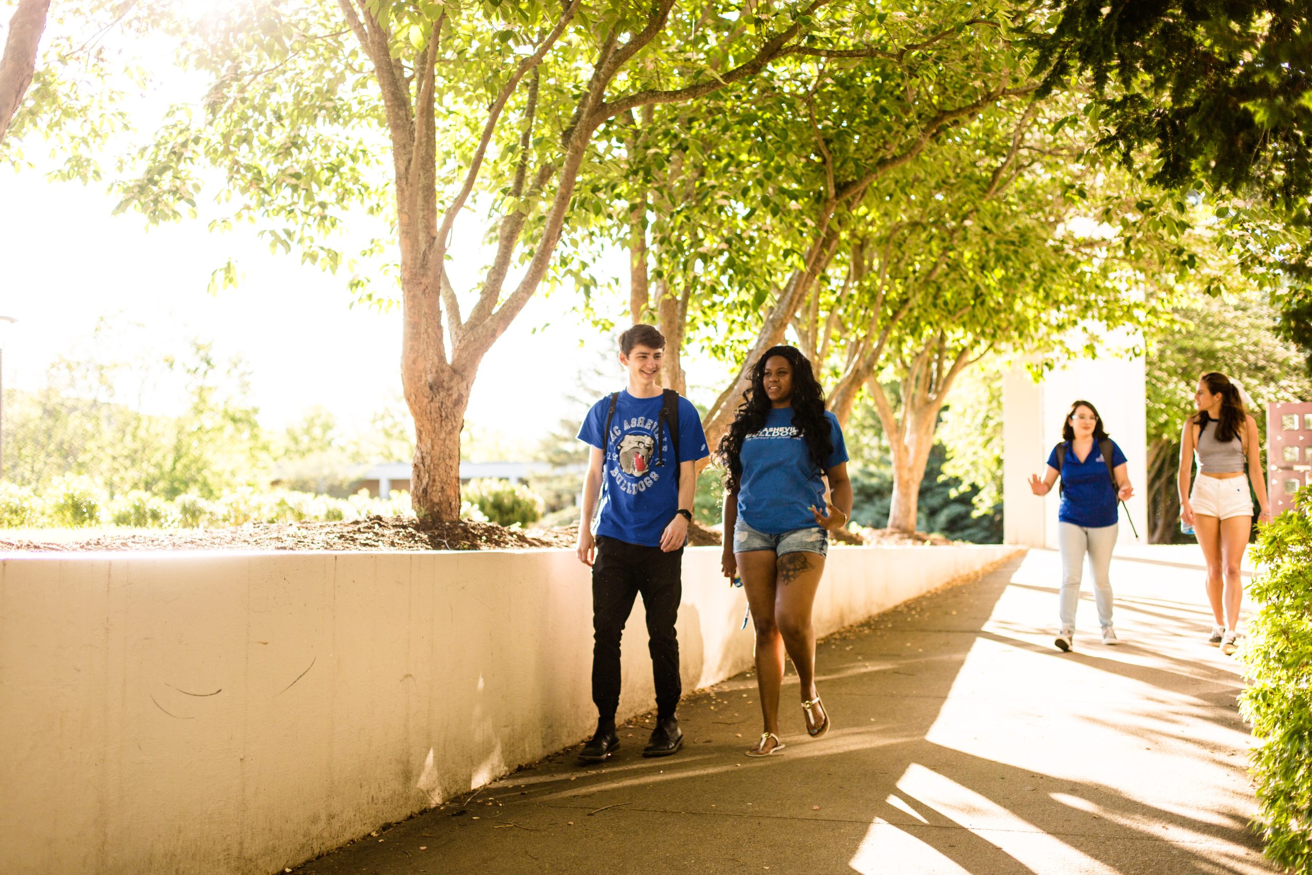 UNC Asheville students walking along sidewalk near the quad