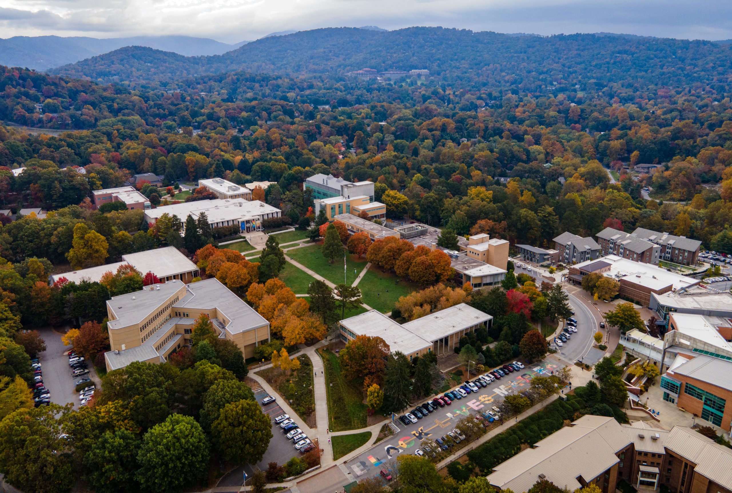 A drone shot of campus with mountains in the background