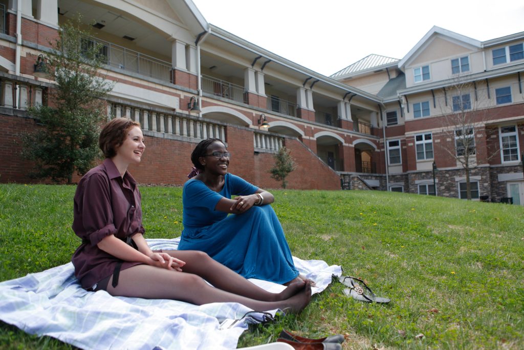 Two students sitting outside at Governor's Hall