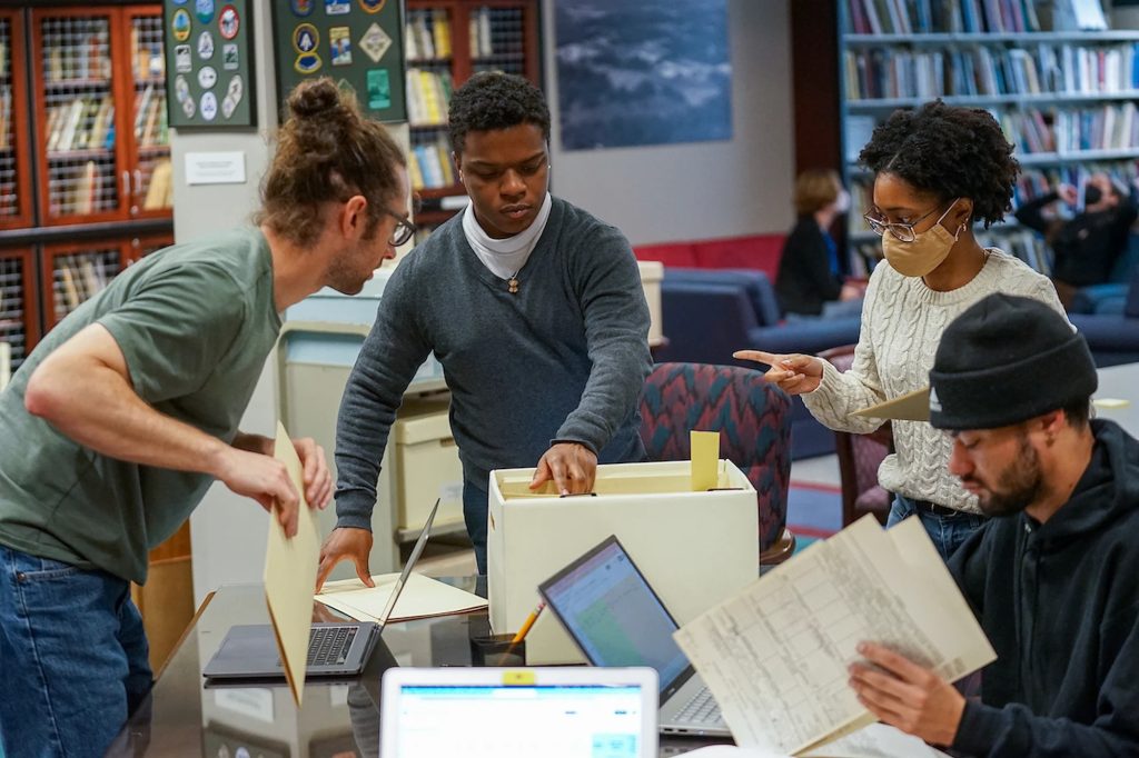 Students in the university archives studying urban renewal in Asheville